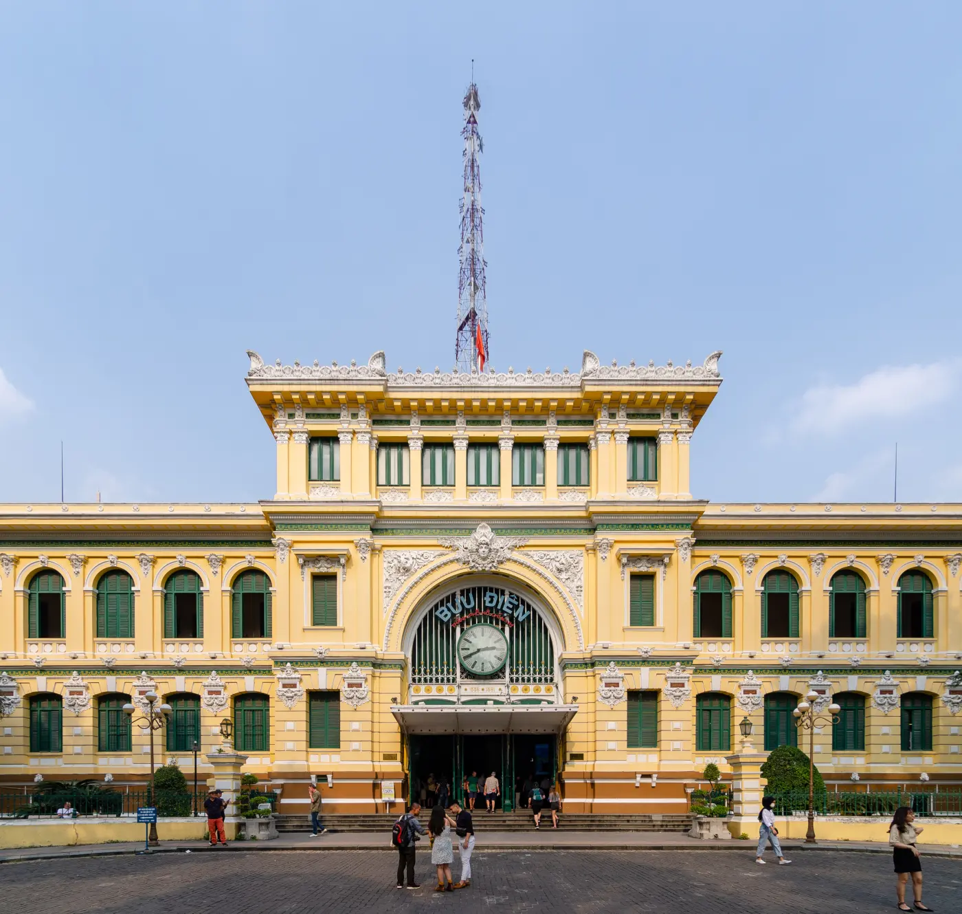 The yellow colonial-era facade of the Saigon Central Post Office in District 1 under a blue sky