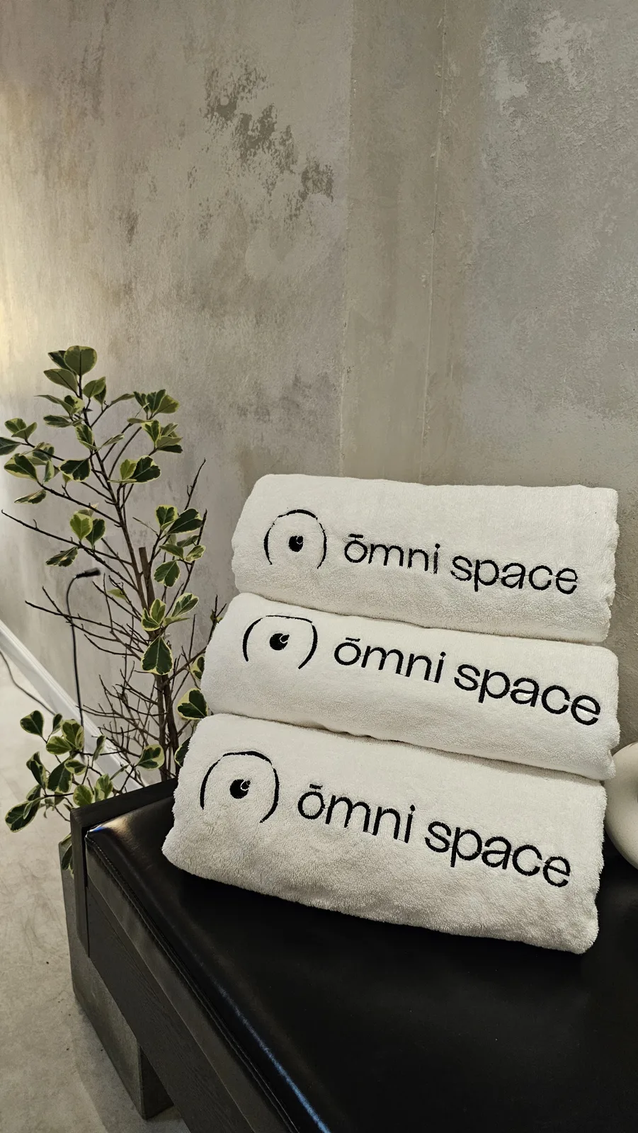 Neatly stacked fresh towels at Ōmni Space
