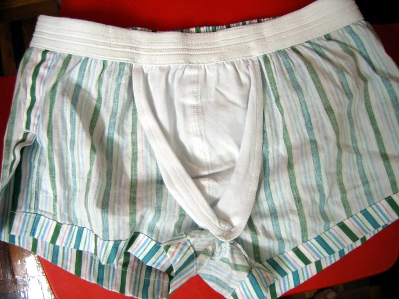 A pair of striped cotton boxer shorts laid flat, turned inside out